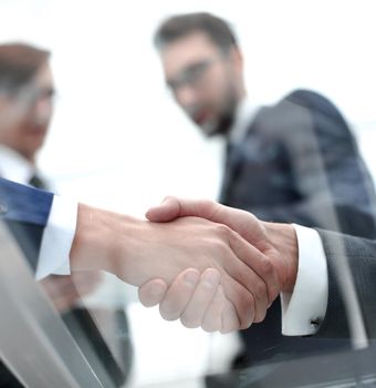 handshake business colleagues in office