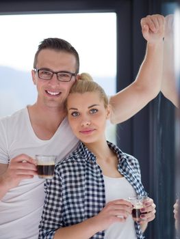 romantic happy young couple enjoying morning coffee by the window in their luxury home