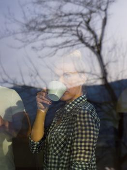 romantic happy young couple enjoying morning coffee by the window in their luxury home