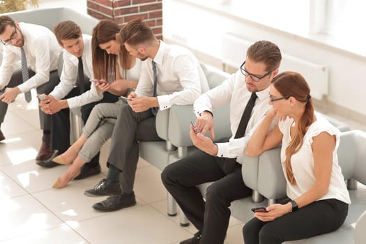business team sitting in the lobby of the business center .business concept