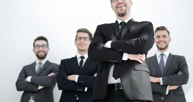 smiling business man standing in front of business team.photo with copy space