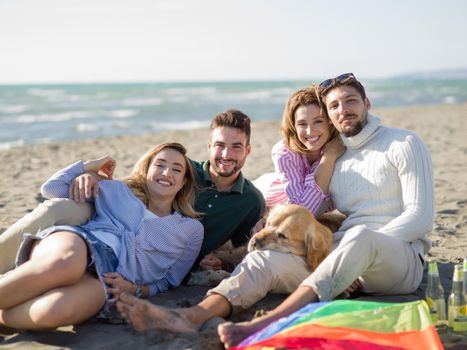 Group Of Young Friends Spending The Day On A Beach during autumn day