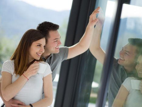 romantic happy young couple enjoying morning coffee by the window in their luxury home