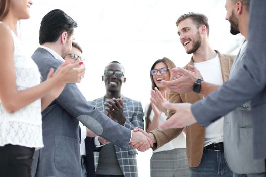 handshake of business partners and applauding business team .the concept of cooperation