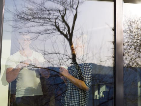 romantic happy young couple enjoying morning coffee by the window in their luxury home