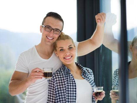 romantic happy young couple enjoying morning coffee by the window in their luxury home