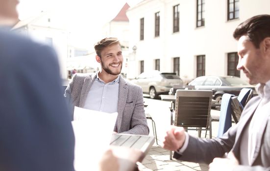 group of business people sitting in a street cafe.concept. photo with copy space
