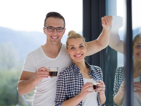 romantic happy young couple enjoying morning coffee by the window in their luxury home