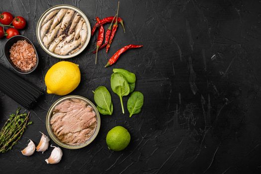 Seafood canned fish mussels food set, on black dark stone table background, top view flat lay, with copy space for text