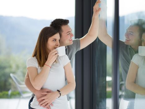 romantic happy young couple enjoying morning coffee by the window in their luxury home