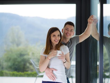 romantic happy young couple enjoying morning coffee by the window in their luxury home