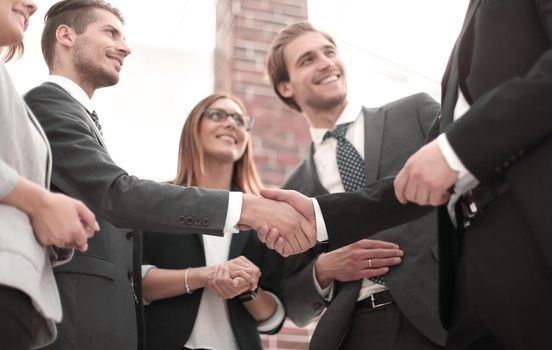 Happy businesswomen shaking hands in office