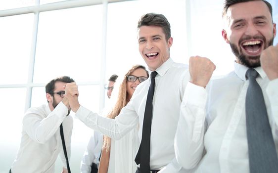 happy employees standing in spacious office.photo with copy space