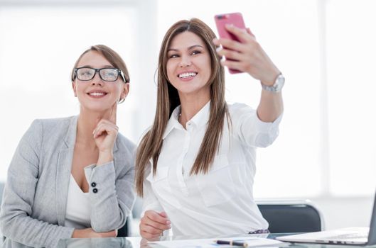 employee and boss taking selfies in the office. photo with copy space