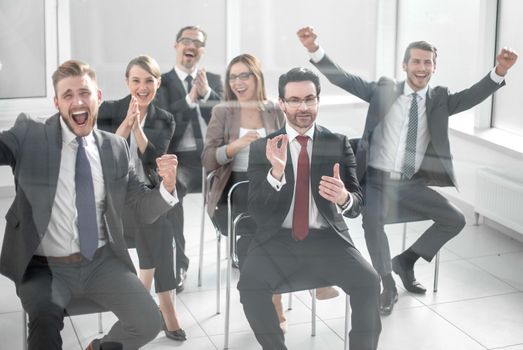 happy business team sitting in conference room. Business and entrepreneurship