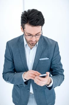 close up. businessman reading SMS on his smartphone.isolated on light background