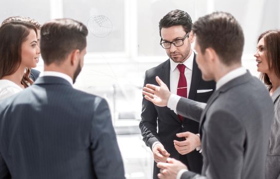 close up.a group of employees talking standing in a circle.photo with copy space