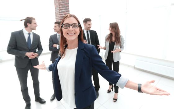 smiling business woman with open hands gesture at the office
