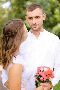 Happy european groom with caucasian bride. Concept of married couple and love.