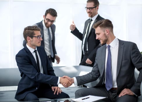 smiling business partners shaking hands.the concept of cooperation
