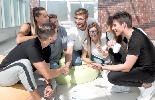 friends shaking hands when discussing a new project. the concept of a startup