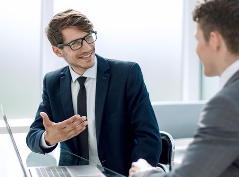 employees discussing online information sitting at the office Desk.people and technology