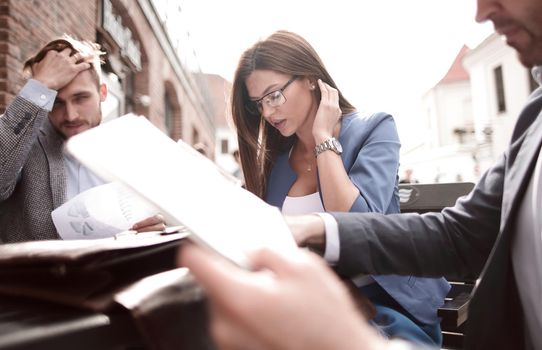 close up. business colleagues, sitting at a table in a street cafe.business concept