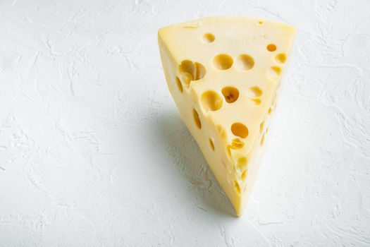 Maasdam cheese set, on white stone surface, with copy space for text