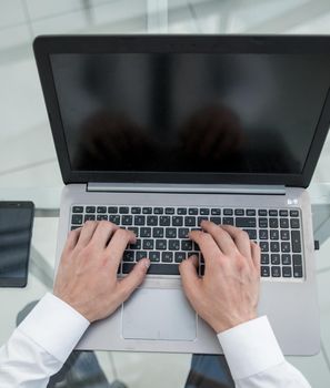 rear view.businessman working on a laptop.close up