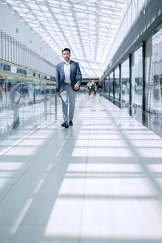 businessman walking in the airport building. the concept of business travel.