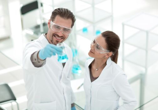 scientist and assistant look at the results of their research.photo with copy spac