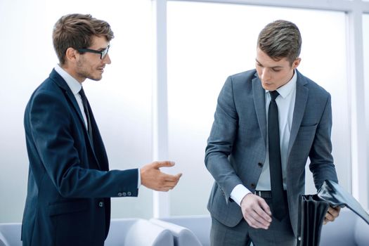 business colleagues discussing new ideas while standing in the office .office weekdays