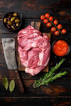 Fresh and raw meat Lamb or mutton set, with ingredients and herbs, on old dark wooden table background, top view flat lay