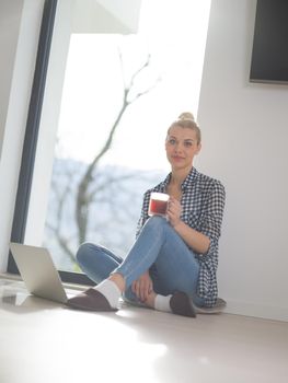 Real Woman Using laptop At Home on the floor Drinking Coffee Enjoying Relaxing