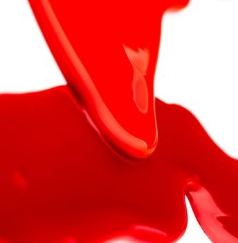 Colorful leaks of red liquid on white background