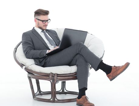 businessman with a laptop sitting in a comfortable chair. photo with text space