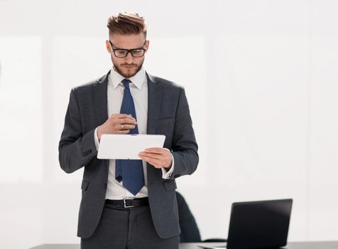 responsible businessman looking at the digital tablet screen .photo with copy space