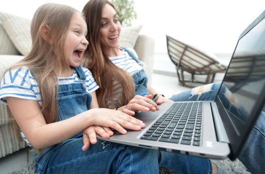 childhood, parenting and technology concept - happy mother with adorable little girl with laptop