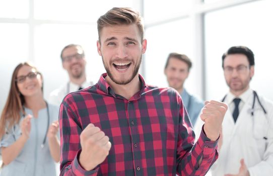 Man in plaid shirt celebrating victory in hospital