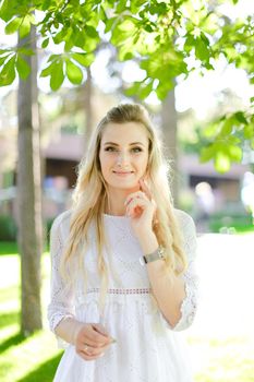 Portrait of young blonde woman wearing white clothes. Concept of beauty and female person.