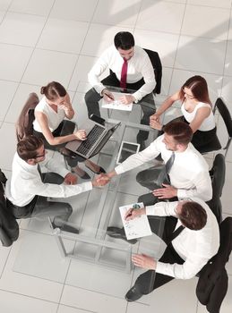 top view of multi ethnic startup business people group on brainstorming meeting in modern bright office interior