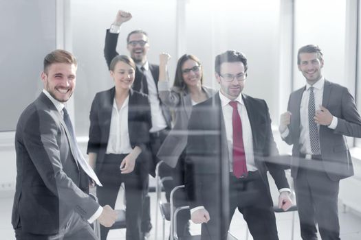 triumphant business team standing in the conference room. winning concept