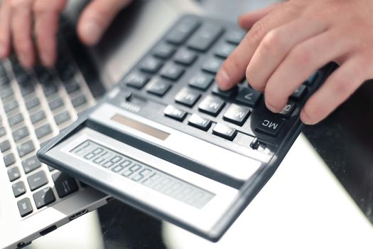 Photo Of Businessperson's Hand Calculating Invoice With Calculator