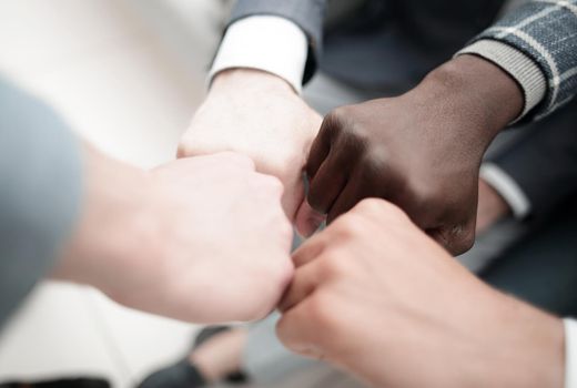 group of business people folded their fists into a circle.the concept of unity