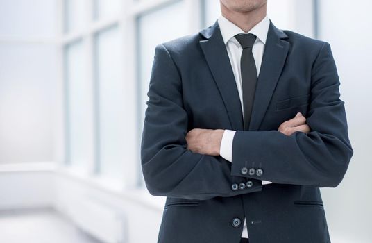 close up.confident businessman standing in the office.business concept