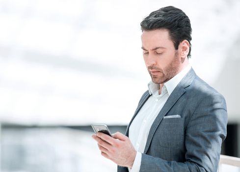 close up.businessman reading text message on smartphone.people and technology