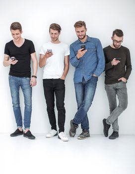 in full growth.group of friends with smartphones.communication concept