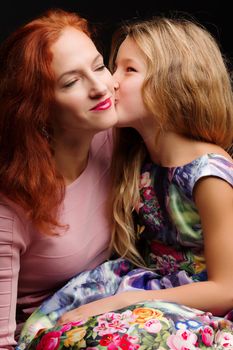 Young mother and little daughter gently embrace. The concept of Happy Childhood, Family Happiness, Raising a Child.