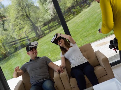 Couple using virtual reality headset in living room at home  people playing game with new trends technology