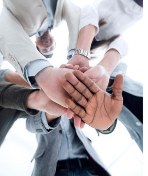 close up.business team folded their hands together.business background